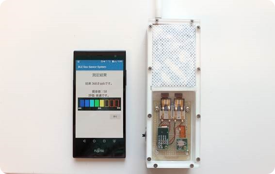 Fujitsu's prototype breath sensor, displaying results on a smartphone. (On-screen text, top to bottom) Measurement Results, Result: 360.0 ppb, Deviation value: 50, Evaluation: Normal 