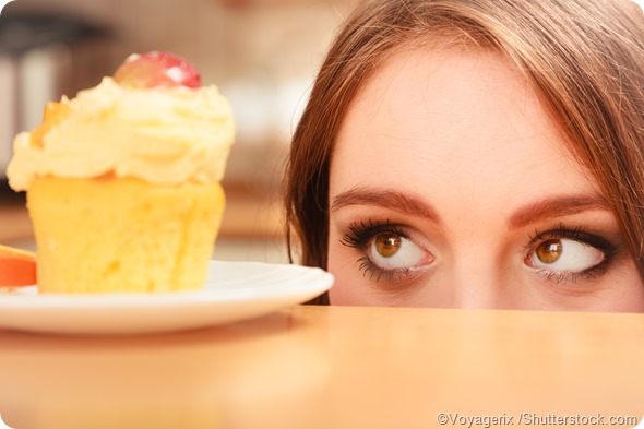 woman looking at cupcake