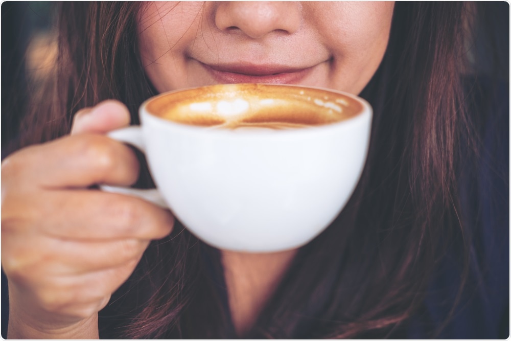 Woman smelling coffee