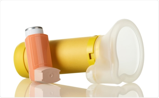 Pictured is a typical inhaler (orange) and spacer (yellow) for treating asthma in children. Image Credit: Laboko / Shutterstock
