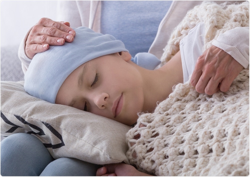 Child with cancer lying on mums knee