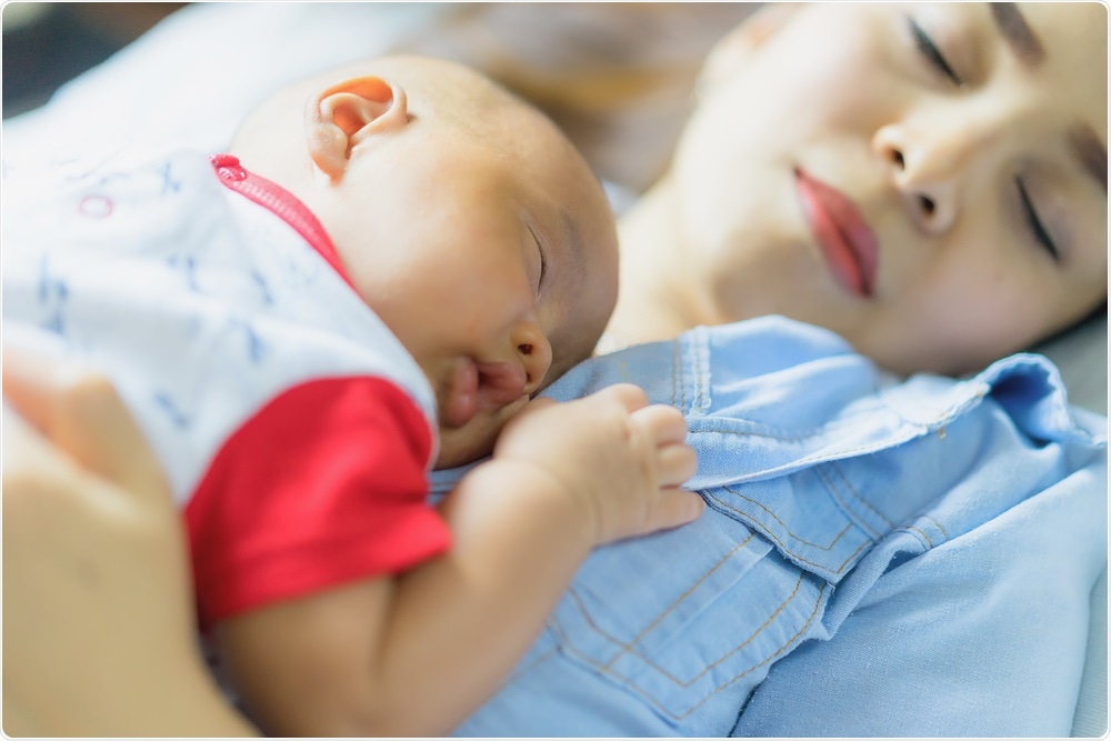 Co-sleeping mother and son - baby sleeps on mothers chest