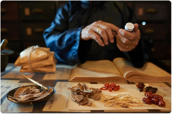 Practitioner making traditional Chinese remedy. Image Credit: Dragon Images / Shutterstock