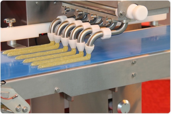 A Food Processing Machine Extruding Strips of Food. Image Credit: Daseaford / Shutterstock