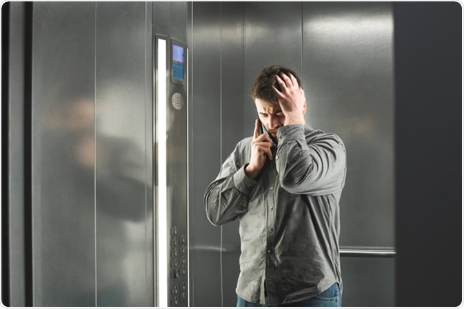 Claustophobia in the elevator. Image Credit: Bodnar Taras / Shutterstock