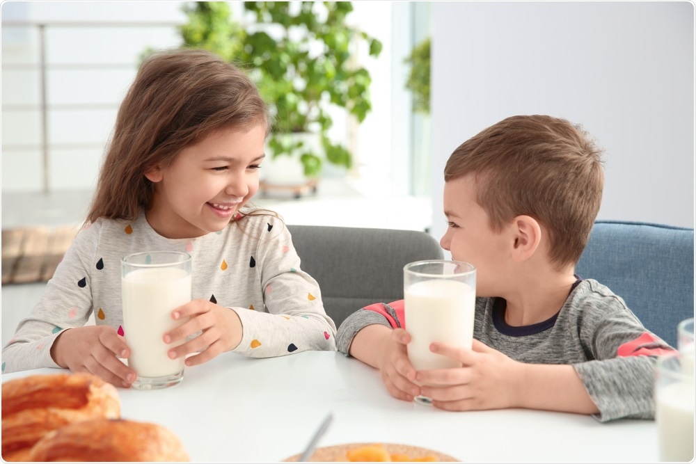 Children drinking cows milk