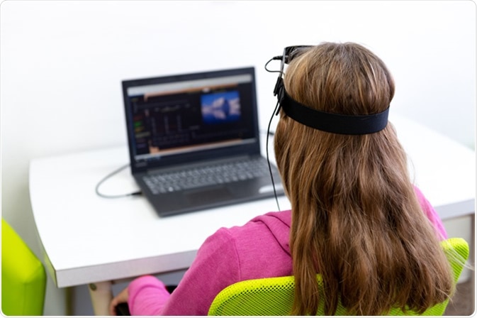 Young teenage girl during EEG neurofeedback session. Image Credit: ABO PHOTOGRAPHY / Shutterstock