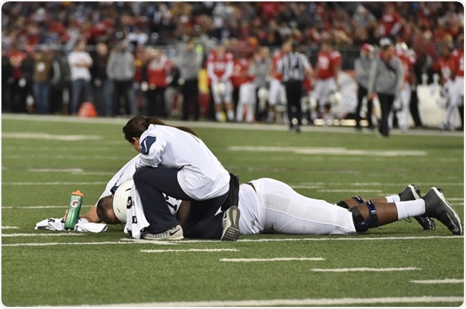 BALTIMORE - OCTOBER 24: Trainers tends to an injured Nittany Lion player during the NCAA football game against Maryland October 24, 2015 in Baltimore. Image Credit: Aspen Photo / Shutterstock