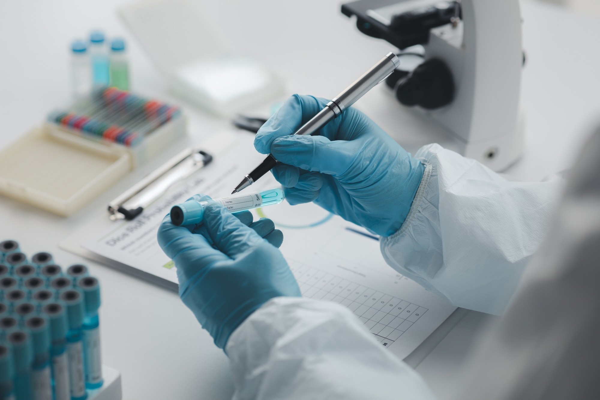 lab assistants collect blood samples from patients and perform chemical reactions