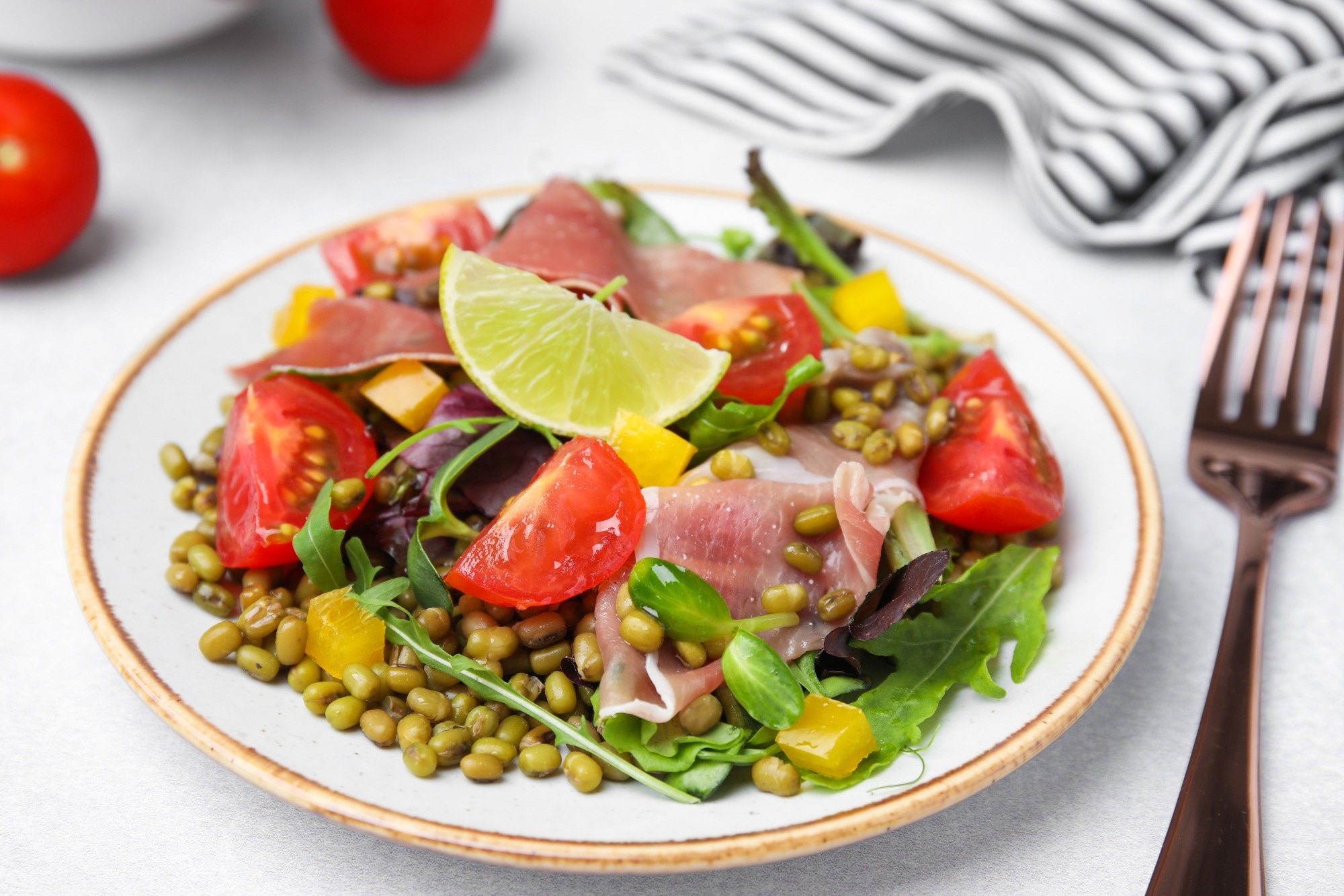 Salad with tomatoes, meat, and millets