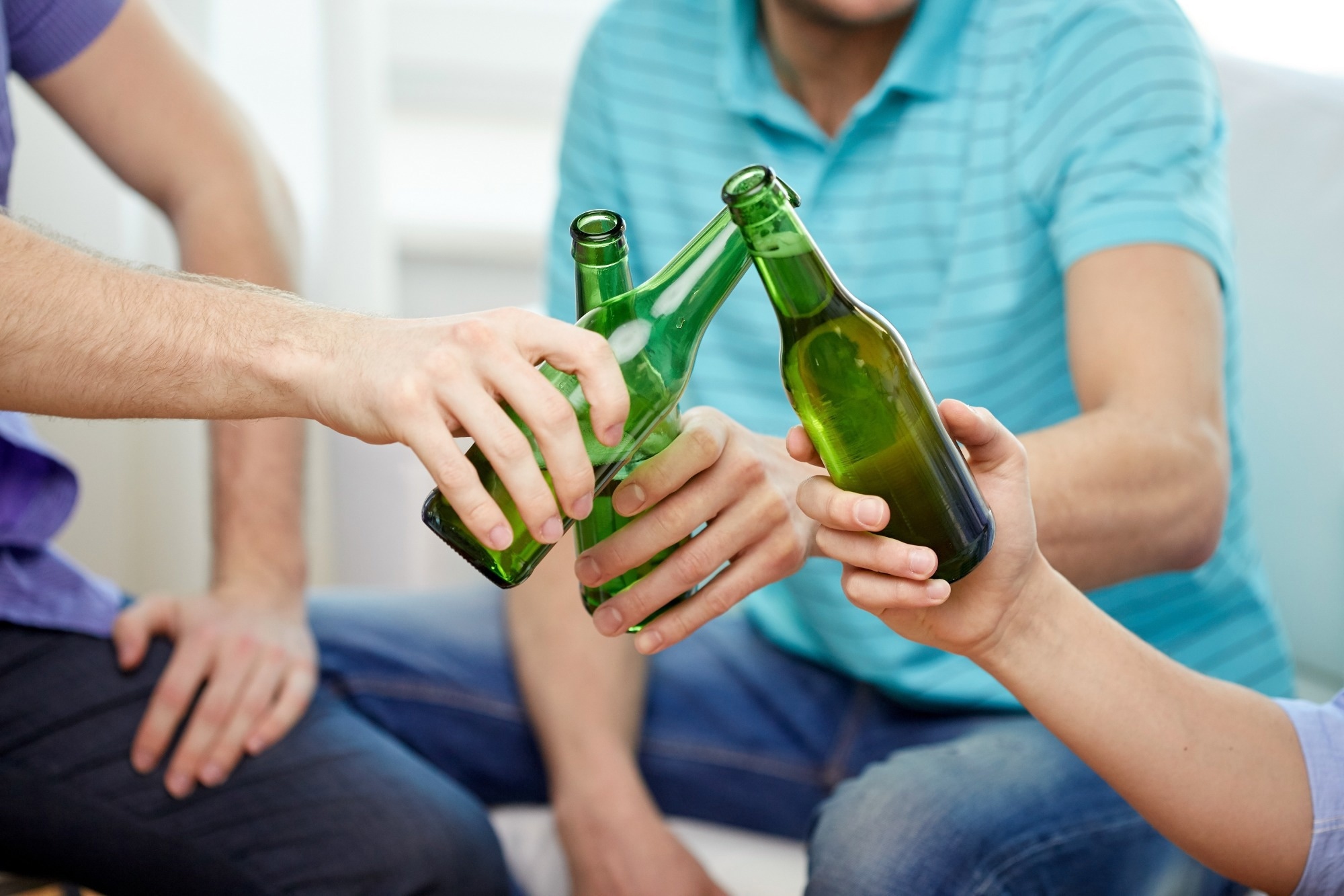 Friends bring beer bottles together