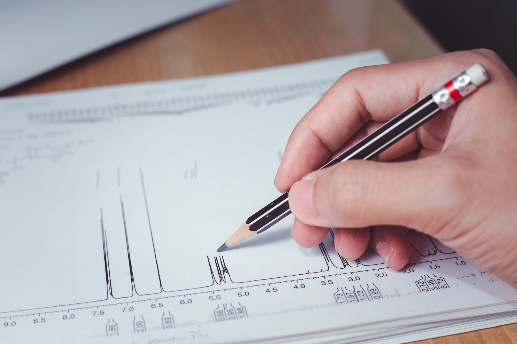 Chemist interpreting proton NMR spectrum, the spectrum of sample analysis by nuclear magnetic resonance spectroscopy, NMR spectroscopy.