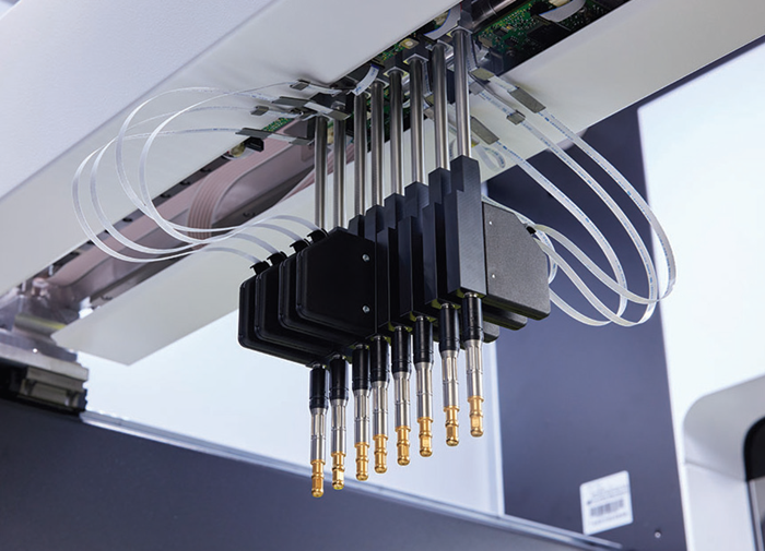 Pipette tips observed from below with visible tubing.