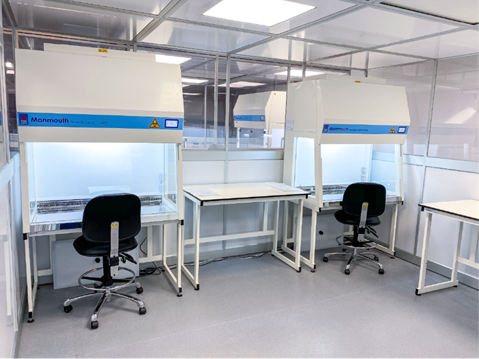 Lab work space with two chairs in front of two fumehoods.