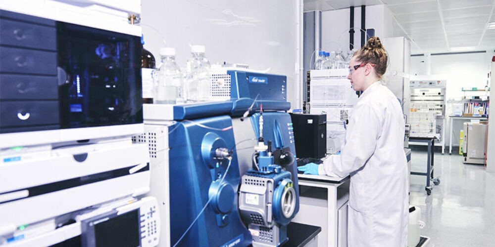 Female scientist operating software in a lab