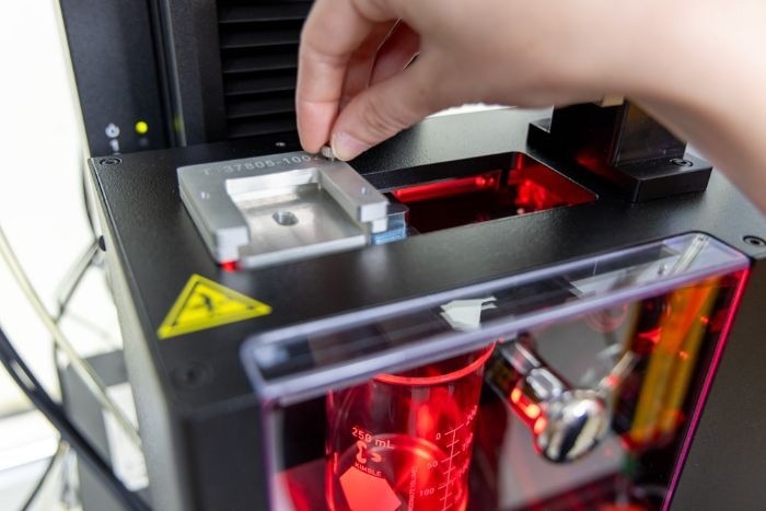Operator changes the insert to accommodate testing of different devices