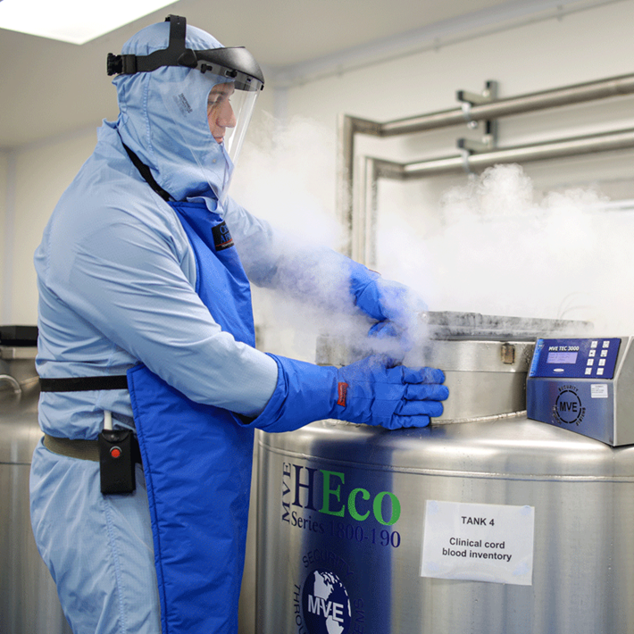 Male scientists working with a cryogenic tank