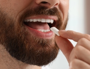 What are the benefits of chewing gum beyond oral health?