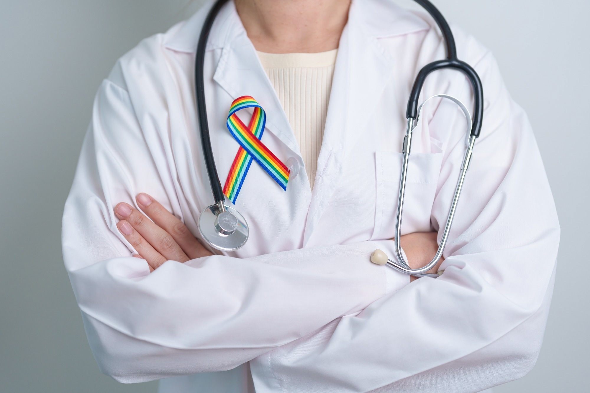 Doctor with LGBTQ Rainbow ribbon for Support Lesbian, Gay, Bisexual, Transgender and Queer community and happy