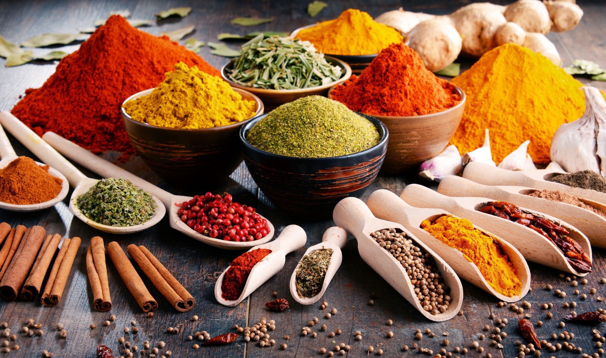 Variety of spices and herbs on kitchen table.