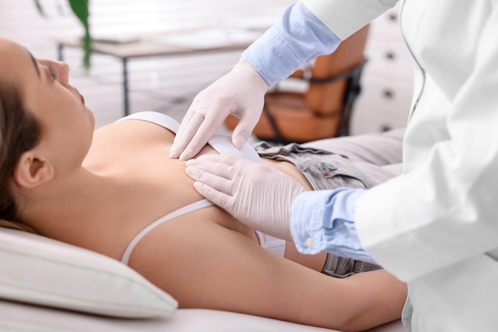 Mammologist checking young woman